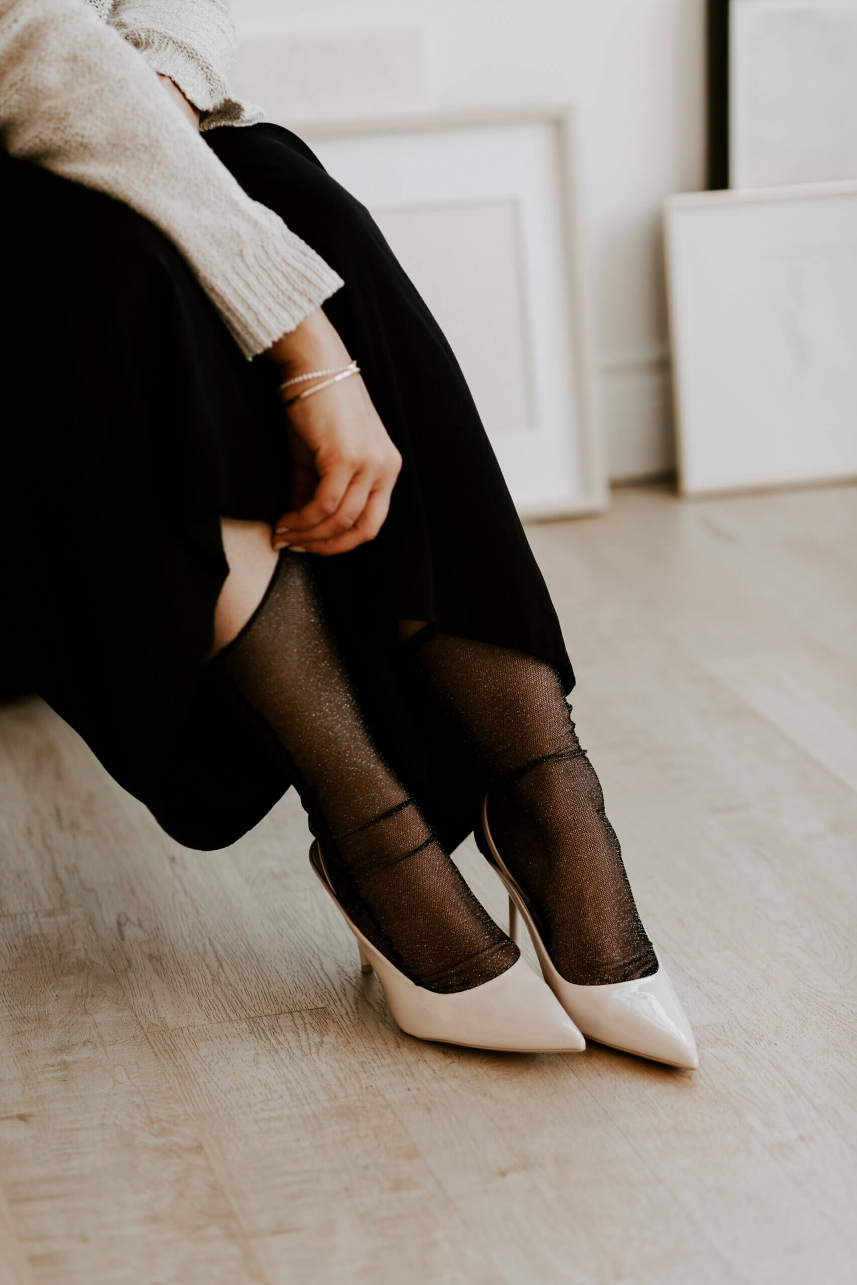 Woman adjusting sheer stockings